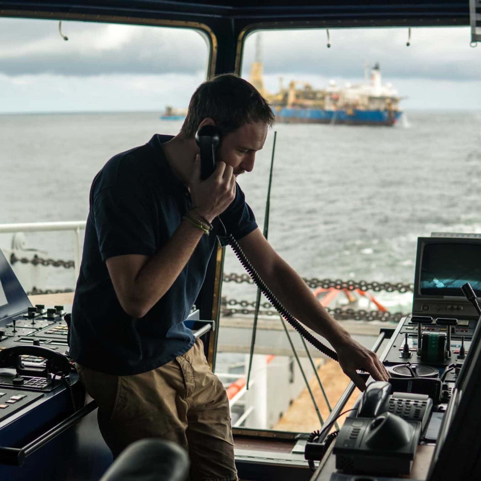 Vessel crew member accessing operational data on a tablet at sea